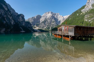 Amazing Sunrise view of Lago di Braies (Pragser Wildsee) with Wooden boats, one of the most beautiful lake in South Tirol, Dolomites mountains, Italy. Popular tourist attraction.