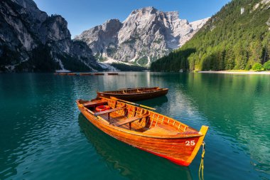 Amazing Sunrise view of Lago di Braies (Pragser Wildsee) with Wooden boats, one of the most beautiful lake in South Tirol, Dolomites mountains, Italy. Popular tourist attraction.
