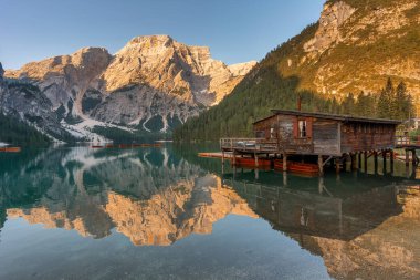 Amazing Sunrise view of Lago di Braies (Pragser Wildsee) with Wooden boats, one of the most beautiful lake in South Tirol, Dolomites mountains, Italy. Popular tourist attraction.