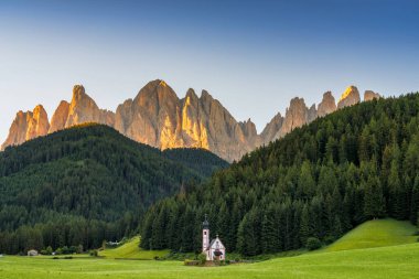 Gün batımında Santa Maddalena 'daki Ranui Şapeli' nde St. John 's ile Dolomitlerin Sahnesi. İtalya