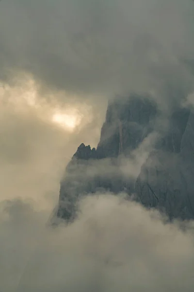 Close up of mountains hidden in fog at Sunrise of Alp De Suisi, Dolomites, Italy