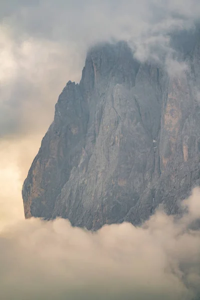 Close up of mountains hidden in fog at Sunrise of Alp De Suisi, Dolomites, Italy