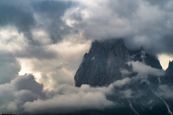 Close up of mountains hidden in fog at Sunrise of Alp De Suisi, Dolomites, Italy