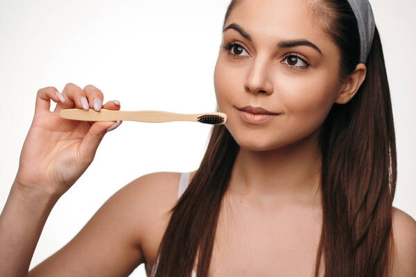 Beautiful Dark Haired Woman Holding Toothbrush While Posing White Studio Royalty Free Stock Images