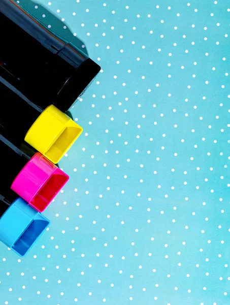 A set of toner cartridges for a color laser printer on a snowy background. Bright creative concept christmas minimal — стоковое фото