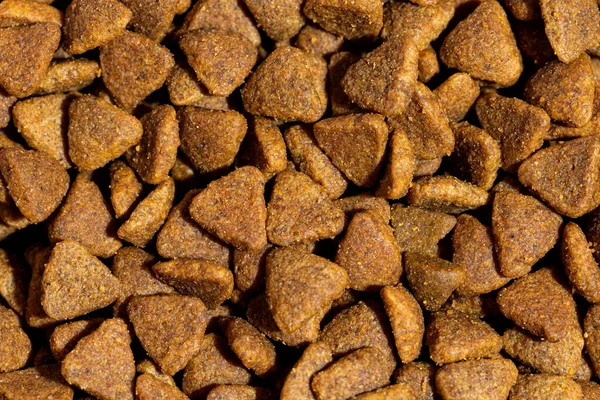 Dog or cat food or kibble shot up close. Top view background.