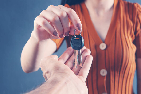 the woman gives the keys to the door