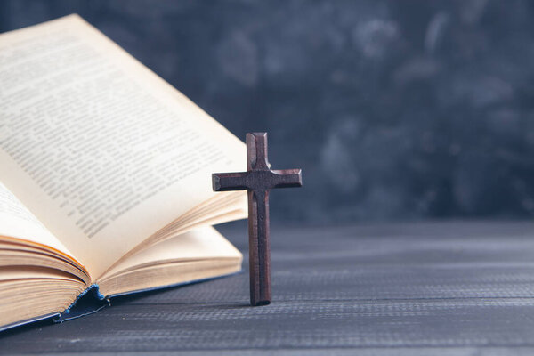 open book and cross on the table