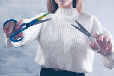 Elinde makas tutan genç bir kadın.