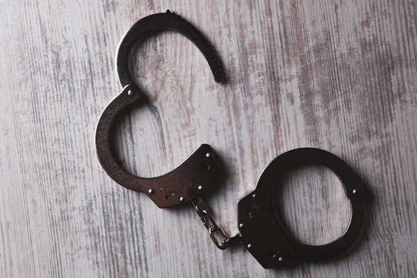 Handcuffs Wooden Table — Stock Photo, Image