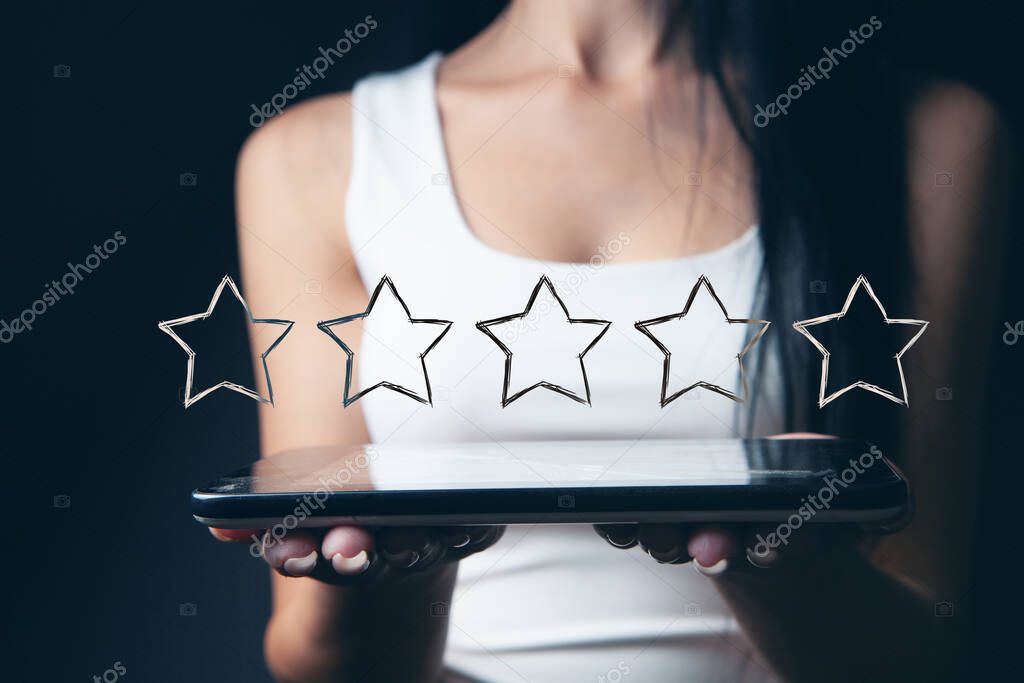 five stars for evaluation. girl holding a tablet. online appraisal