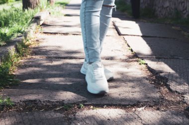 Parkta bir kadın yürüyor.