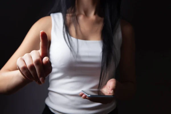 young woman pressing the screen while holding the phone