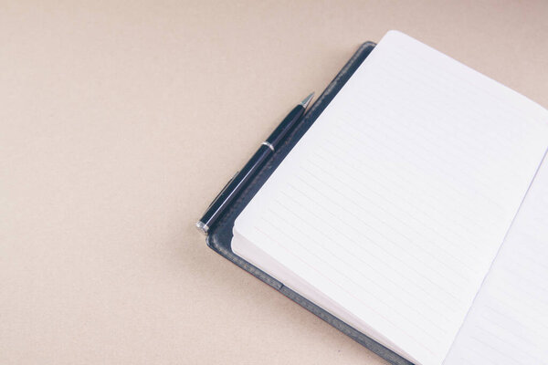 notebook and pen on the table