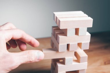 Ahşap küplerden bir yapı yapan bir iş adamının yakınlaşması. Bir iş konsepti inşa etmek.