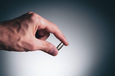 closeup man hand holding pills