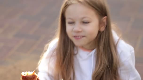 Portrait of smiling child sneezing, scratching nose and eats a croissant, seasonal allergy — Stock Video