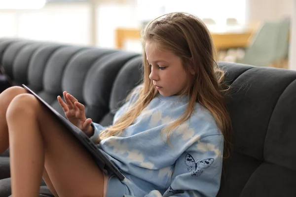 Adorable Niña Usando Tableta Digital Viendo Dibujos Animados Sentada Sofá —  Fotos de Stock