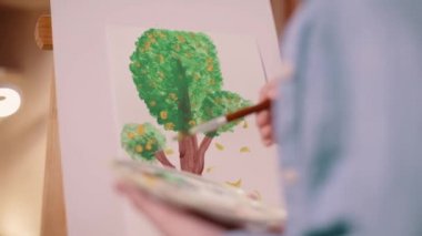 Kız evde ağaç boyuyor..