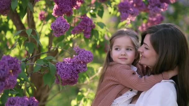 Young Mother Holds Cute Little Daughter Her Arms Flowering Tree — Stock Video