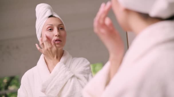 Young Attractive Woman Bathrobe Applies Cream Her Face Bathroom View — Video