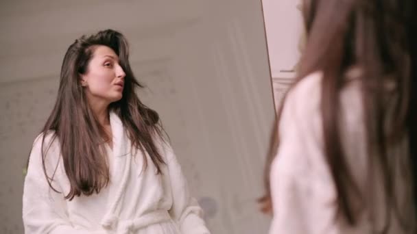 Young Attractive Woman Bathrobe Examines Her Hair Mirror — Stockvideo