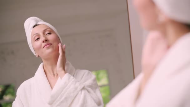 Young Attractive Woman Bathrobe Applies Cream Her Face Bathroom View — Video