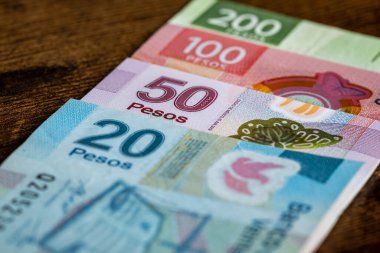 Mexican money,various banknotes stacked on the table