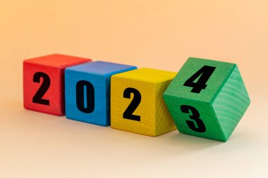 2023 to 2024, Numbers on joyfully colored blocks, Merry Christmas and a Happy New Year, Apricot background 