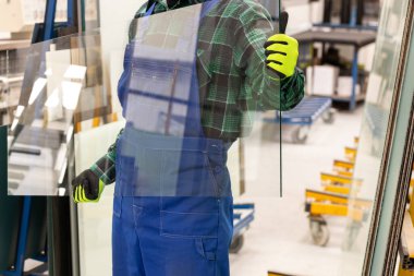 Camcı elinde cam bir bölme taşıyor, Cam Fabrikası. 