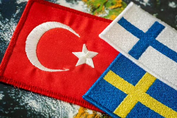 Turkish flag next to the flags of Finland and Sweden Concept of a political conflict between a member of the North Atlantic Pact and candidates aspiring to join