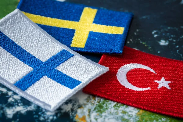 The Turkish flag next to the flags of Finland and Sweden. Concept of a political conflict between a member of the alliance and the candidates for membershi