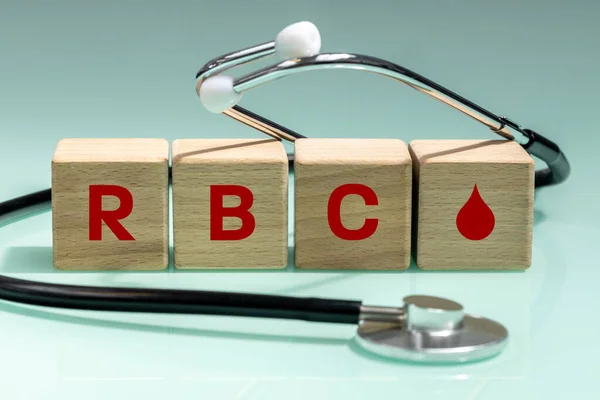 wooden blocks with the words RBC, red blood cells, count,  corpuscles, Medical stethoscope, concept of blood tests and laboratory results