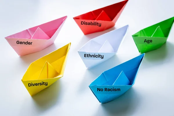 Handmade, colorful paper ships, a variety of symbols, the concept of tolerance and acceptance of various social, ethnic and gender groups, creative concept of equality of belonging,