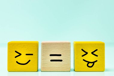 Positive balance, wooden blocks with a hand drawn smile, an equal sign between them, Concept, Equality gives joy and happiness