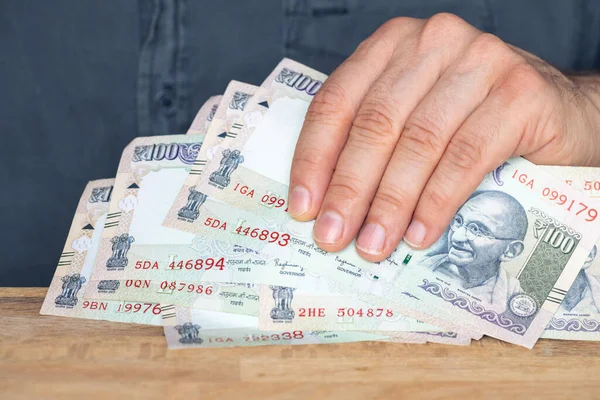 Indian rupees, File of banknotes held in the hand, Concept of financial success, winning or a hit financial investment