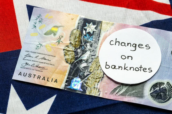Change of the image on the Australian dollar banknote, Money lying on the Australian flag with the manual inscription: change on banknotes