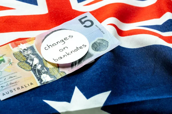 Change of the image on the Australian dollar banknote, Money lying on the Australian flag with the manual inscription: change on banknotes