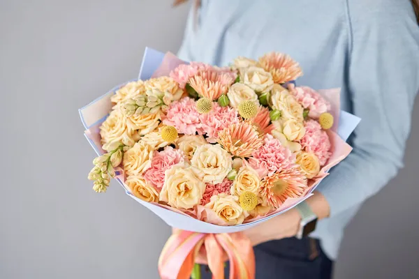 Kadın elinde güzel bir buket çiçek. Çiçek dükkanı konsepti. Taze kesilmiş güzel bir buket. Çiçek teslimatı