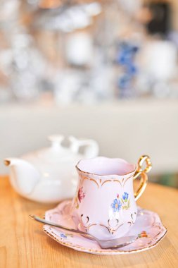teapot and cup. A magnificent porcelain tea set with a fragrant tea. Green and black tea concept. Side view