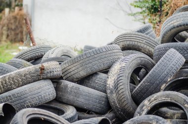 Bir yığın hasarlı, eski, hurda, geri dönüşüm için araba lastikleri..
