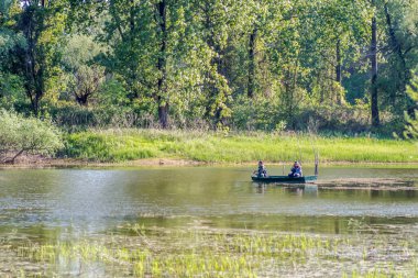 Novi Sad, Sırbistan - 17 Ağustos. 2019: Novi Sad yakınlarındaki gölde bir teknede balıkçılar