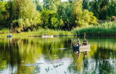 Novi Sad, Sırbistan - 17 Ağustos. 2019: Novi Sad yakınlarındaki gölde bir teknede balıkçılar