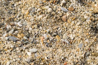 Yunanistan 'ın Pefkochori kentindeki küçük turist kasabasında öğleden sonra kumsalda çakıl taşları.