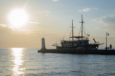 Anchored tourist boat by the waterfront in Pefkochori, Greece. Anchored tourist boat in the morning hours, tied to the waterfront in Pefkochori, Greece.