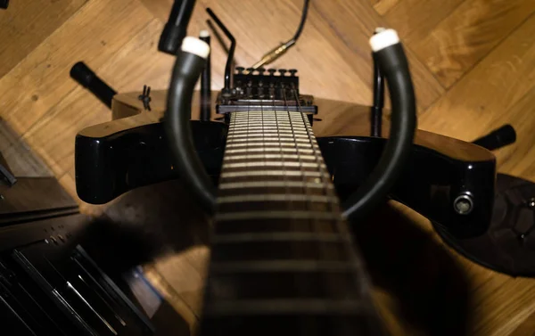 A look at the acoustic bass guitar. View down the neck of a four string bass guitar.