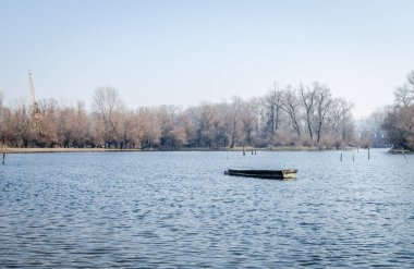 Panoramic view of the Danube river delta in winter. A view of the Danube river delta in winter and the forgotten boats in the water.