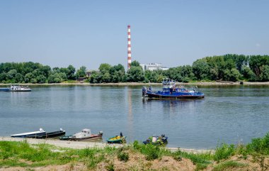 Tugboat on the Danube River. Tugboat passing by moored tankers on the Danube River.