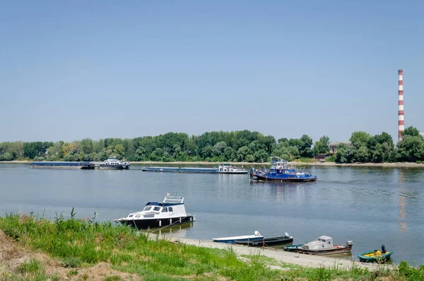 Tugboat on the Danube River. Tugboat passing by moored tankers on the Danube River.