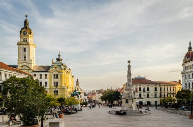 Pecs, Hungary - October 06, 2018: Obeliskl - Monument St. Trinity in Pecs in front of Mosque Qazim in the Main Square in Pecs Hungary.